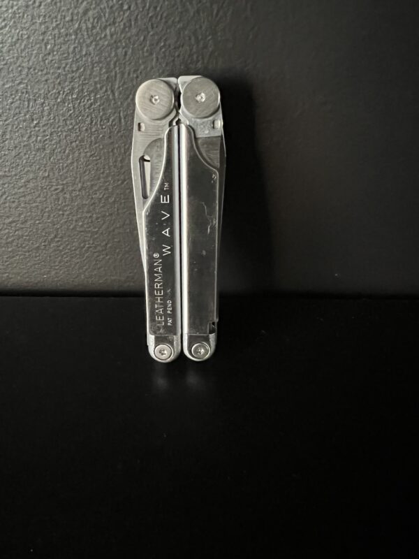 Original Leatherman Wave iin its closed position hinges towards the top, stainless steel in color