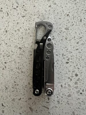 Retired Black Leatherman Style CS in the closed position with the carabiner facing up