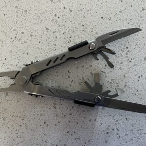 Stainless Steel Gerber MP400 pliers open on the left and the all the tools displaying open on the right