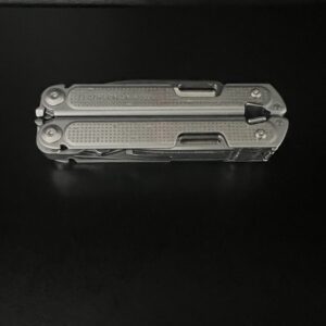 Closed Leatherman Free P4 Stainless steel colored with a black background