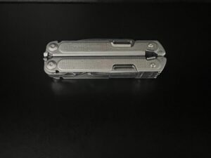 Closed Leatherman Free P4 Stainless steel colored with a black background