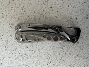 Stainless Steel Skeletool in closed position with the carabiner to the right