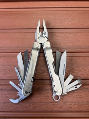 Stainless Steel Leatherman Supertool 300 with pliers open and tools fanned