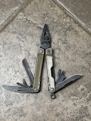 Tan Leatherman Rebar with the pliers open and the tools fanned open