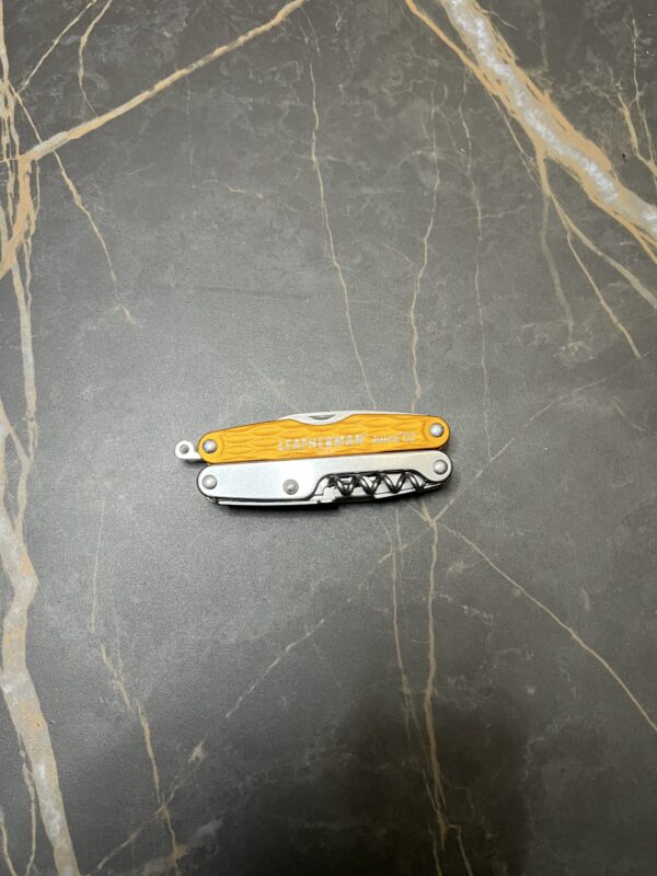 Sunrise Orange Leatherman C2 in the closed position with the lanyard ring sticking out on the left side