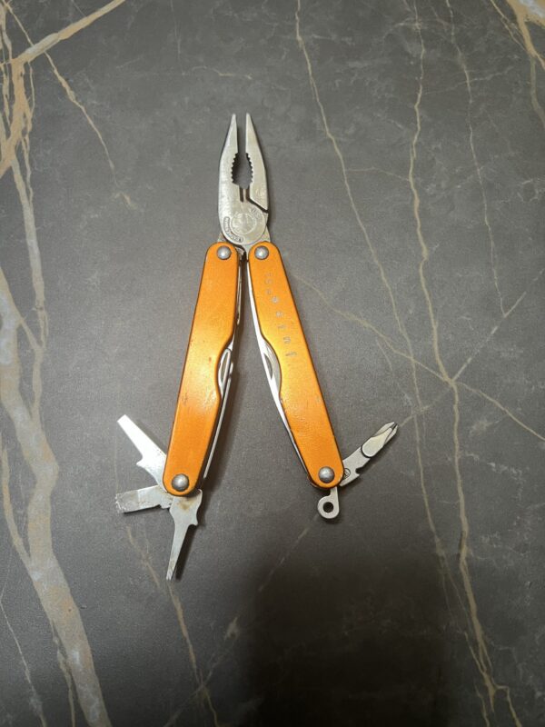 Sunrise Orange Leatherman S2 with pliers open and inner tools fanned