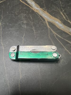 Green and Stainless Steel Leatherman Micra in the closed position